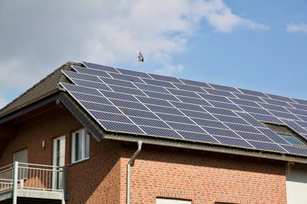 Low angle shot of PV solar panels on the roof of a building