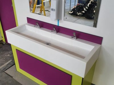 a bathroom vanity with two sinks and a mirror