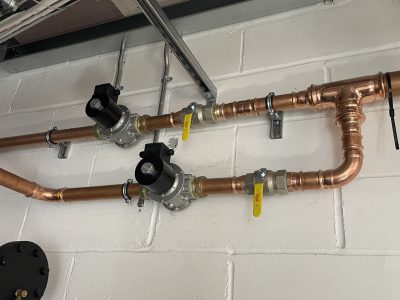 a couple of pipes that are connected to a wall