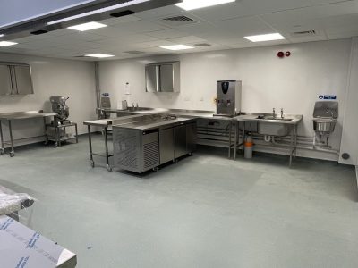 a commercial kitchen with stainless steel appliances and counters