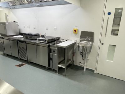 a commercial kitchen with stainless steel appliances and counters