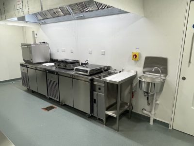 a commercial kitchen with stainless steel appliances and counters