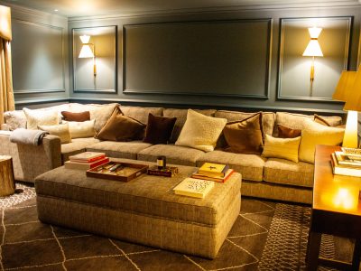 a cinema room with lights and a long sofa