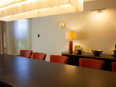 a conference room with a large light and chairs