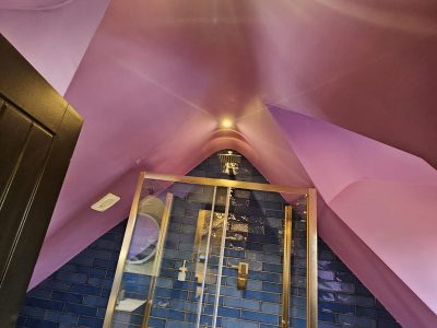 a bathroom with a purple ceiling and a glass shower